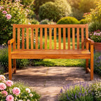 Front view of a 2-seater wooden garden bench on a paved path, framed by lavender and pink flowers in summer